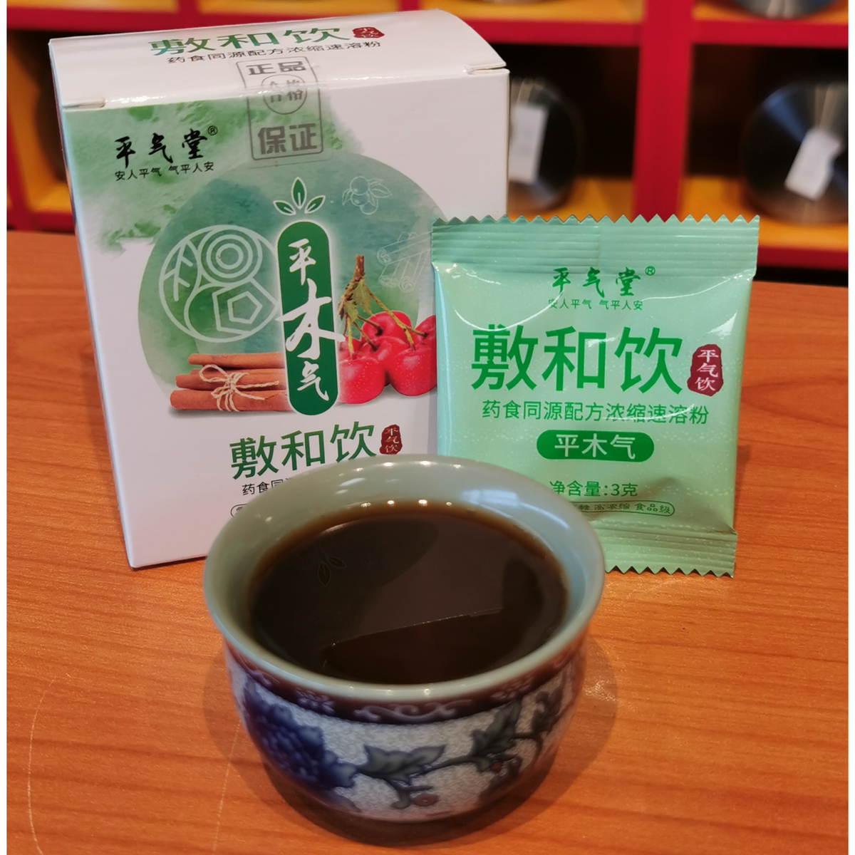 A cup of steaming herbal tea made from Balanced Liver Vital Energy concentrate on a wooden table.