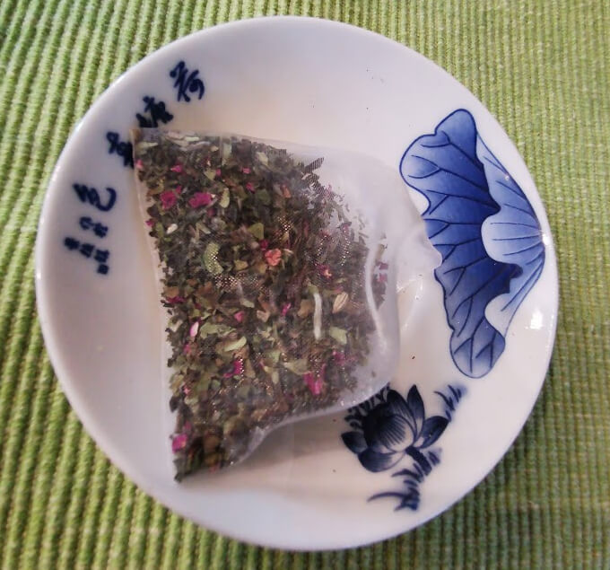 Rose white tea bag in a plate.